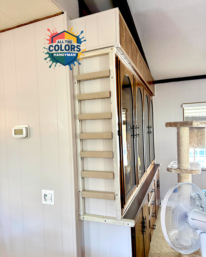 Interior photo of a patio door with curtains in front of it. A sheer grey-patterned curtain hangs closest to the door. It's mostly covered by a light blue blackout curtain. Both curtains are just kissing the floor. It looks neater than before.